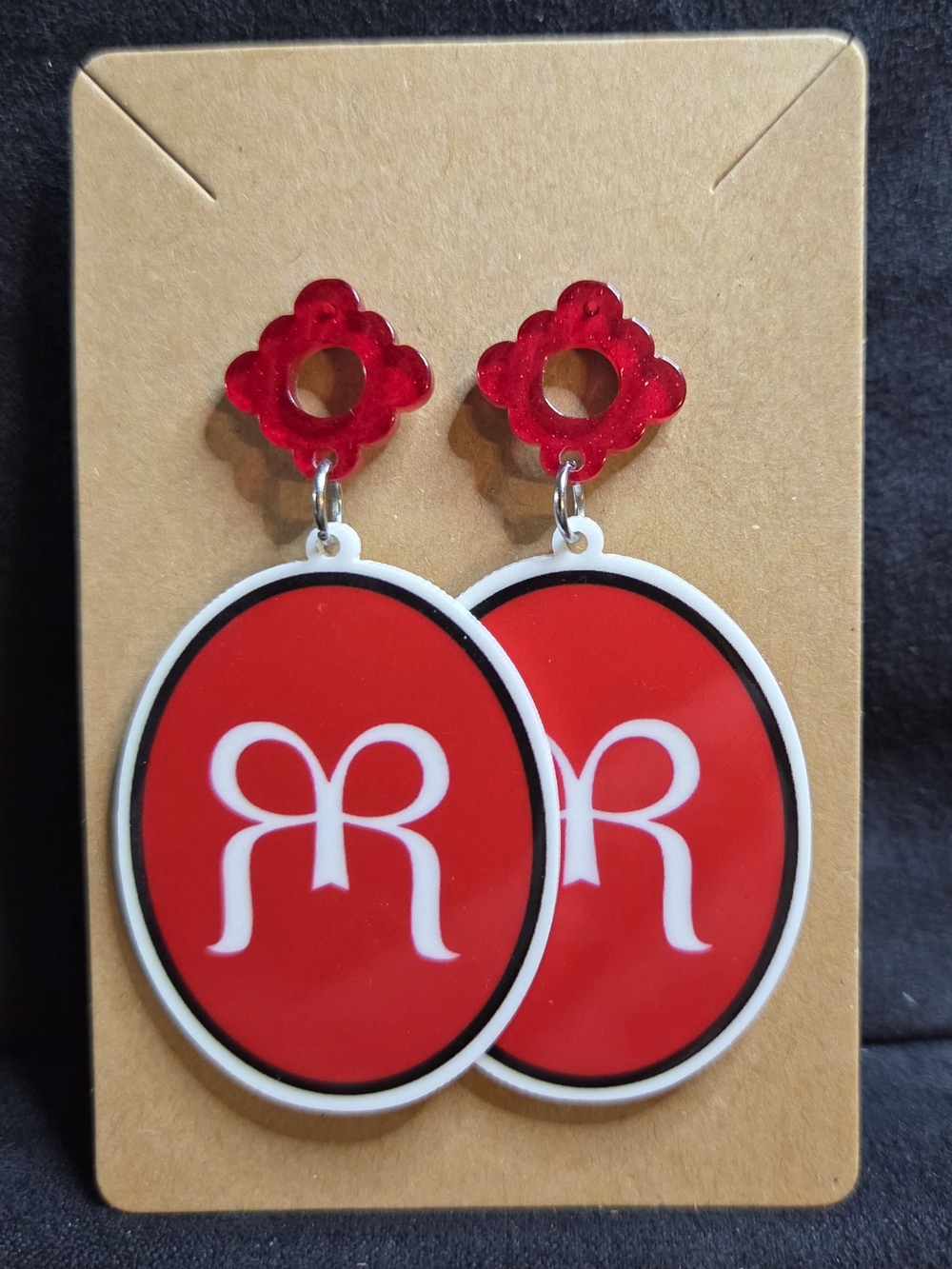 Ruby Ribbon Drop Earrings with White Logo Accent